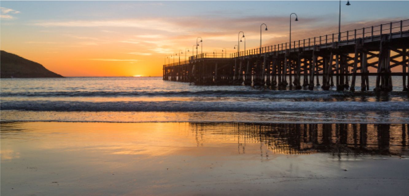 The sun rises behind Coffs Harbour’s famous pier.