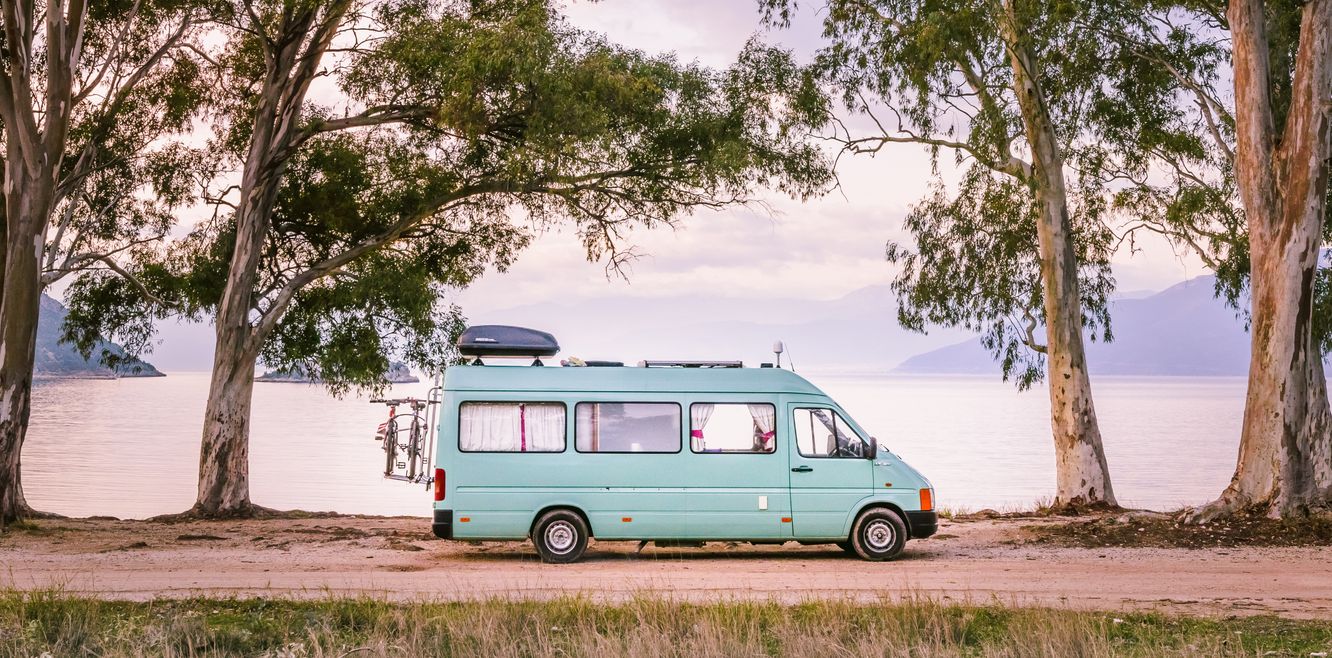 Campervan parked by the water.