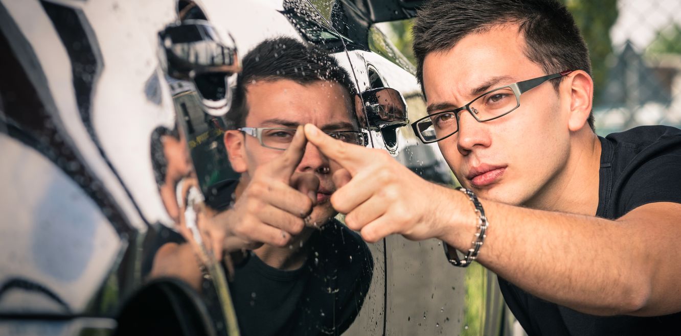 Man checks his hire car for damage