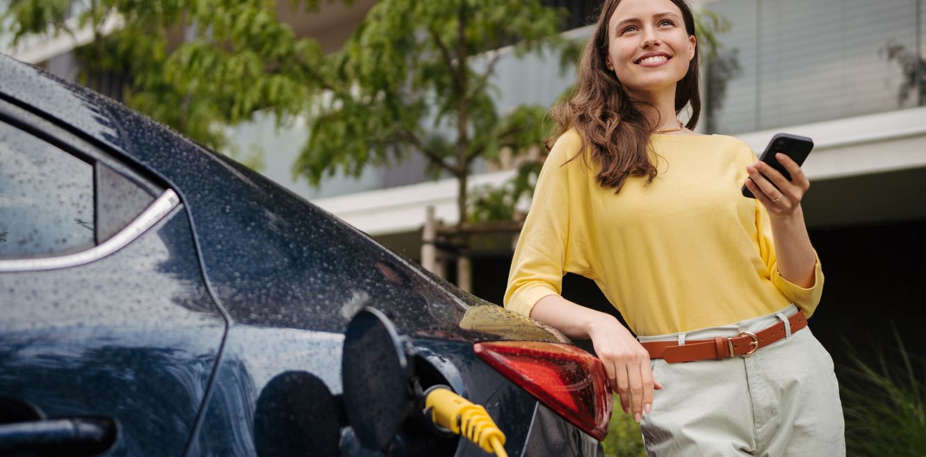 Woman charging her electric car