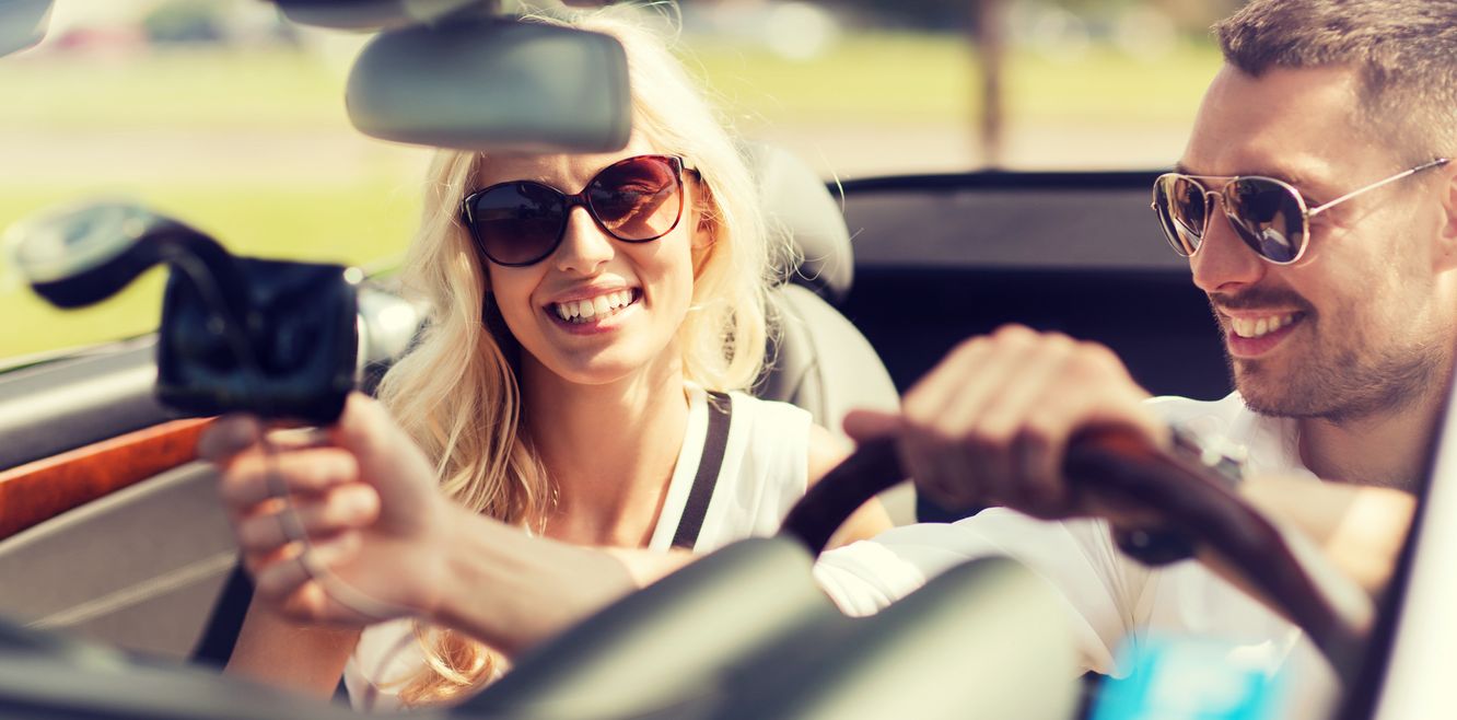 Couple using a GPS in a rental car