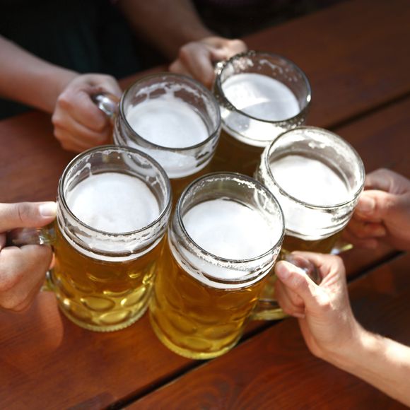 People clinking beer glasses.