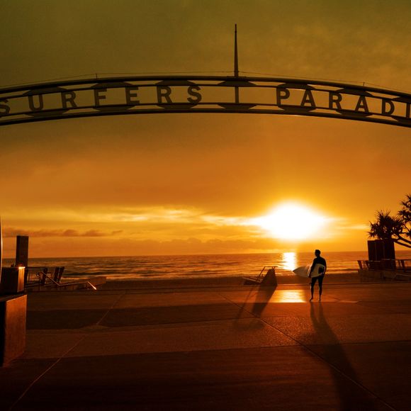 Catch an early morning wave at Surfers Paradise.